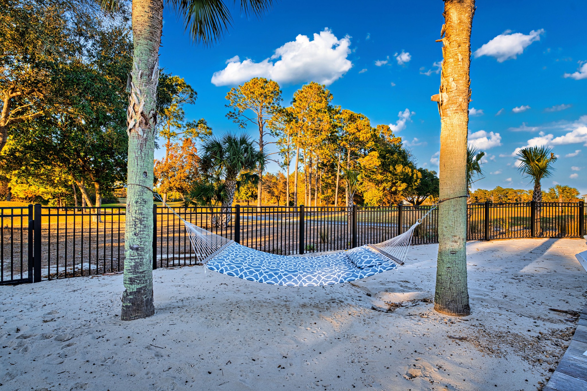 A hammock strung between palms on the sand area at St. James Bay